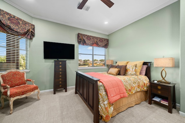 carpeted bedroom with ceiling fan and crown molding