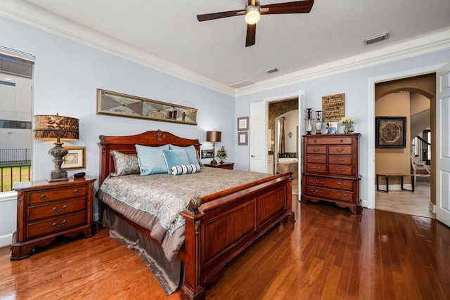 bedroom featuring crown molding, dark hardwood / wood-style floors, ceiling fan, and ensuite bathroom