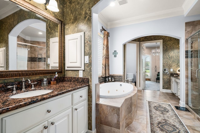 bathroom featuring crown molding, vanity, and separate shower and tub