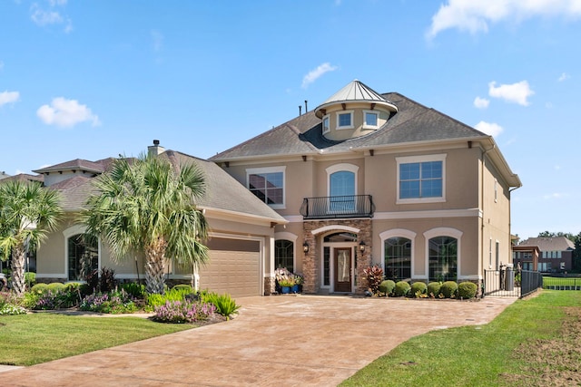 view of front of property featuring a balcony and a front lawn