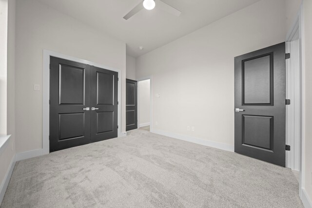 unfurnished bedroom with carpet flooring, a closet, and ceiling fan