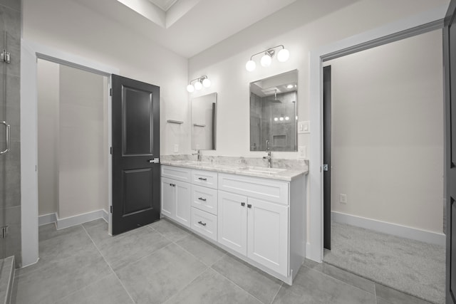 bathroom featuring vanity, walk in shower, and tile patterned flooring