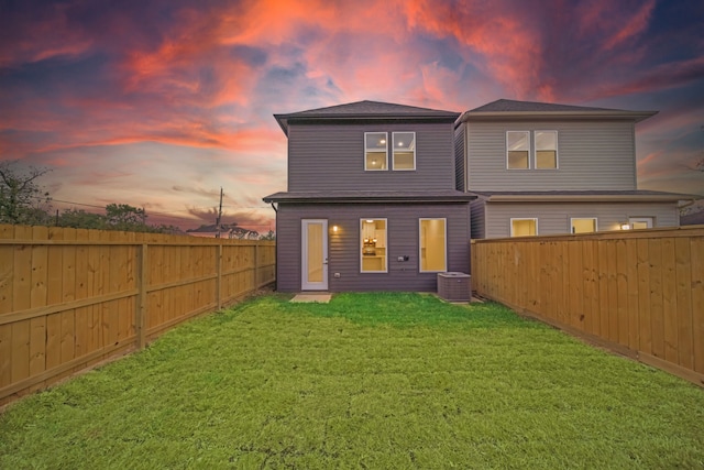 back house at dusk with a yard