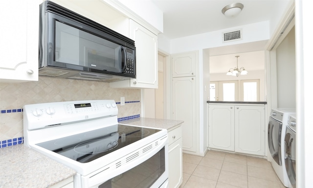 kitchen with white electric range, hanging light fixtures, a notable chandelier, and white cabinetry