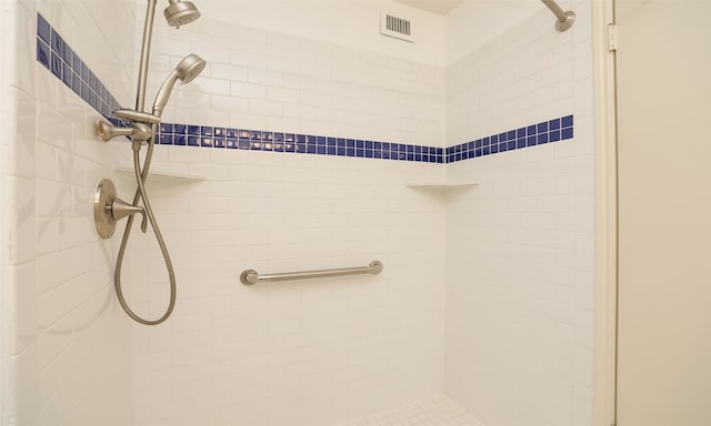 bathroom with tiled shower