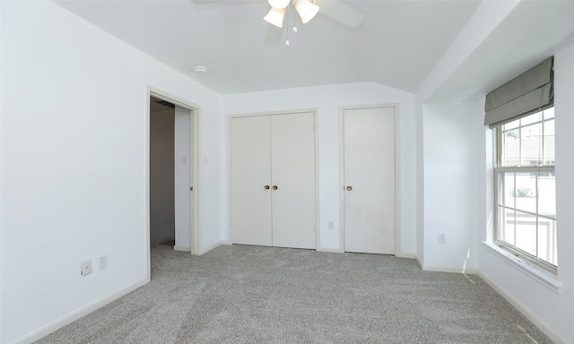 unfurnished bedroom with ceiling fan and light colored carpet