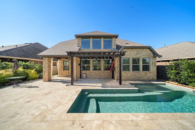 back of property with a pergola and a patio area