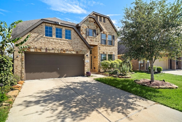 view of front facade with a front yard and a garage