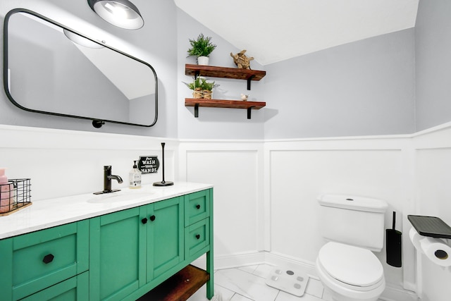 bathroom featuring lofted ceiling, vanity, and toilet