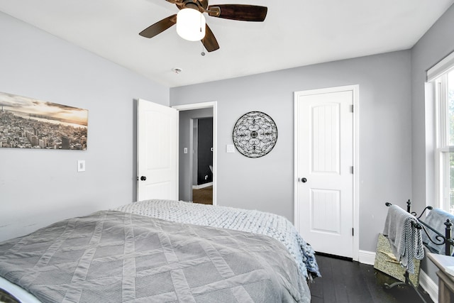 bedroom with dark hardwood / wood-style floors and ceiling fan