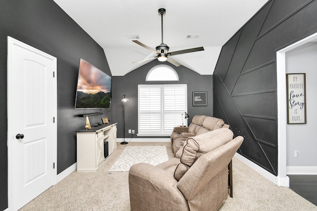 living room featuring ceiling fan, lofted ceiling, a fireplace, and light carpet