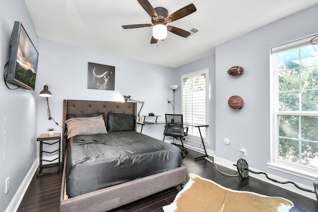 bedroom with ceiling fan and dark wood-type flooring