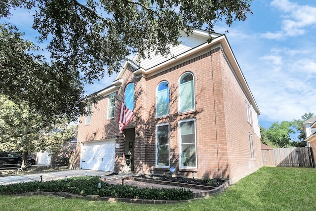 view of front facade featuring a front yard and a garage