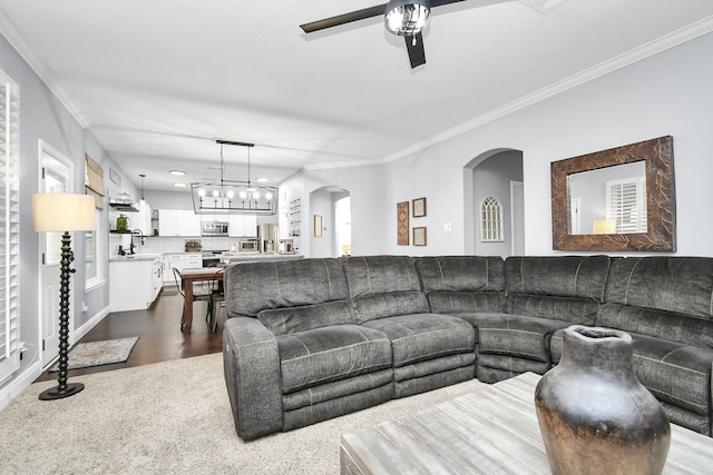 living room with ceiling fan, sink, ornamental molding, and dark hardwood / wood-style flooring