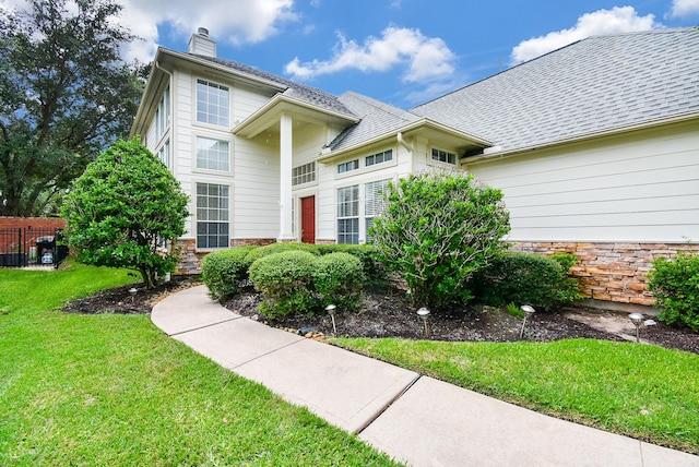 view of property featuring a front yard