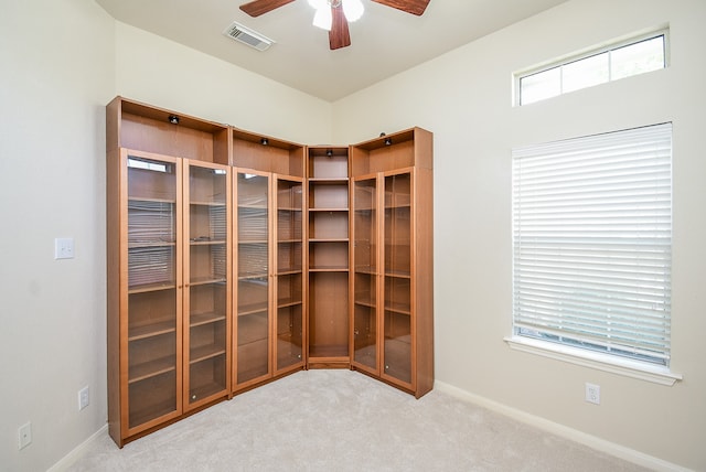 unfurnished room featuring light carpet and ceiling fan