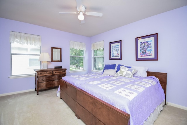 bedroom with ceiling fan and light carpet