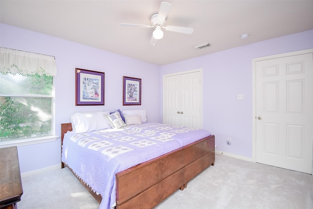 carpeted bedroom featuring a closet and ceiling fan