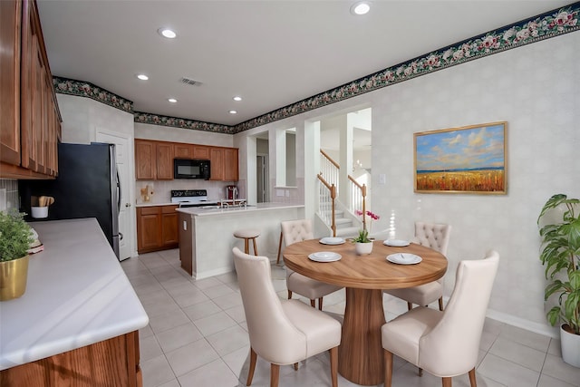 dining space featuring light tile patterned flooring