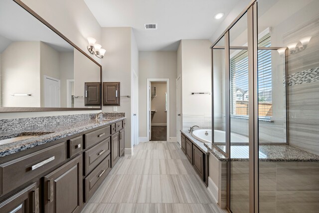 bathroom featuring vanity, separate shower and tub, and tile patterned floors