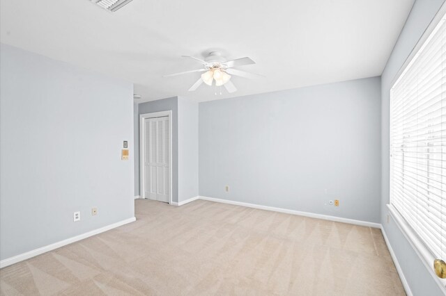 600 Wilcrest Dr Unit 8, Houston, TX 77042 - spare room featuring light colored carpet, a ceiling fan, and baseboards