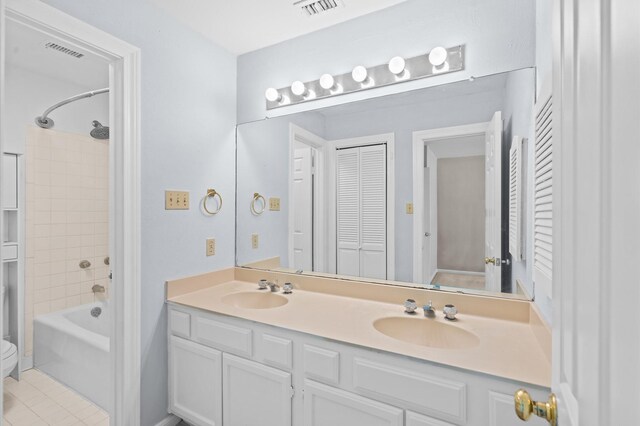 600 Wilcrest Dr Unit 8, Houston, TX 77042 - bathroom with double vanity, a closet, bathtub / shower combination, tile patterned floors, and toilet