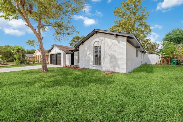 view of front of home with a front yard and a garage