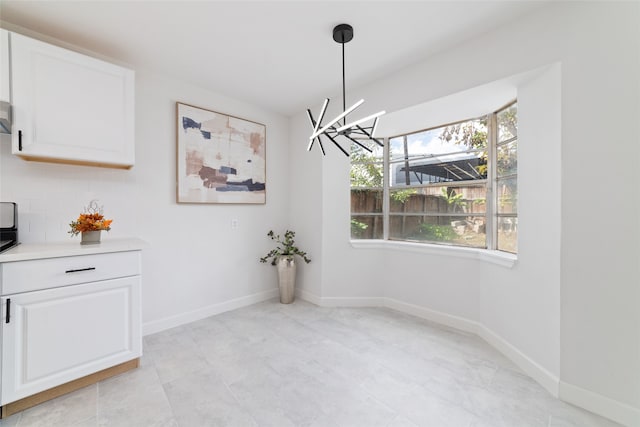 unfurnished dining area with a chandelier