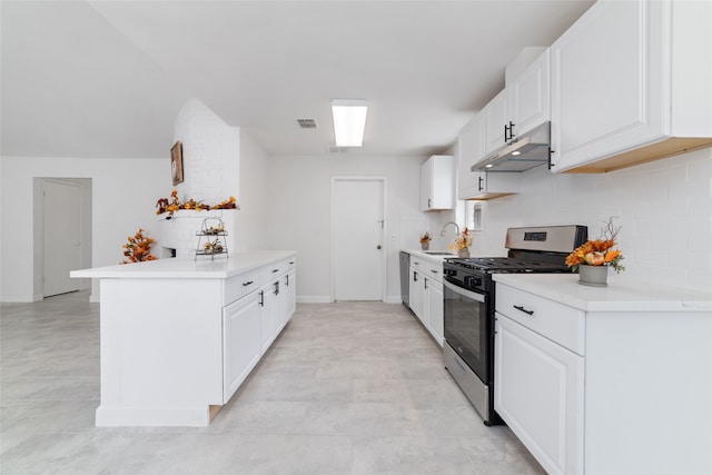 kitchen featuring white cabinetry, tasteful backsplash, kitchen peninsula, stainless steel range with gas stovetop, and sink