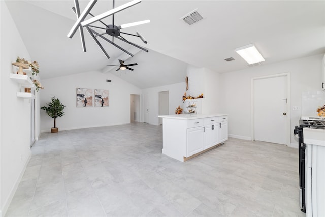 kitchen featuring white cabinets, vaulted ceiling, ceiling fan, and gas stove