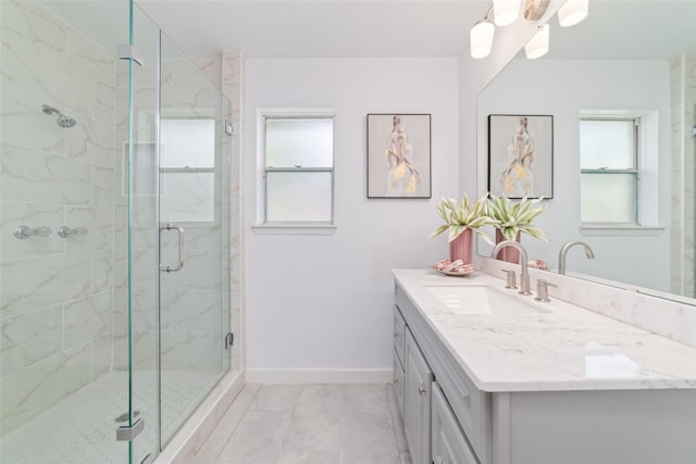 bathroom featuring tile patterned flooring, vanity, and a shower with shower door