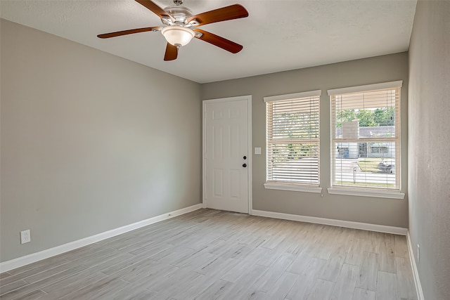 unfurnished room with ceiling fan and light hardwood / wood-style floors