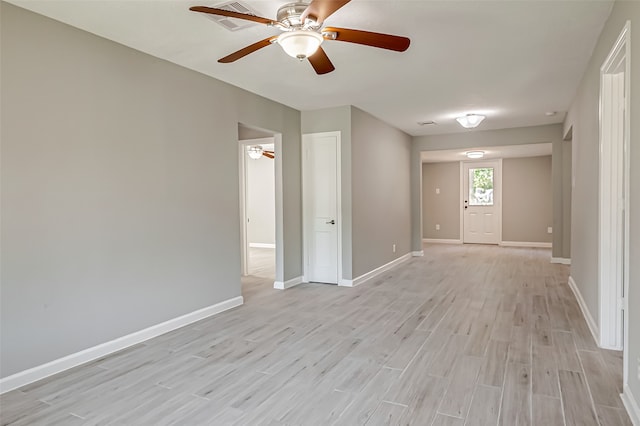 empty room with light wood-type flooring and ceiling fan