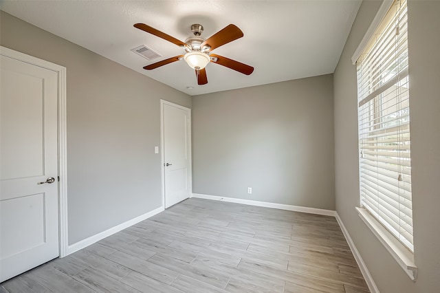 spare room featuring ceiling fan and light hardwood / wood-style flooring