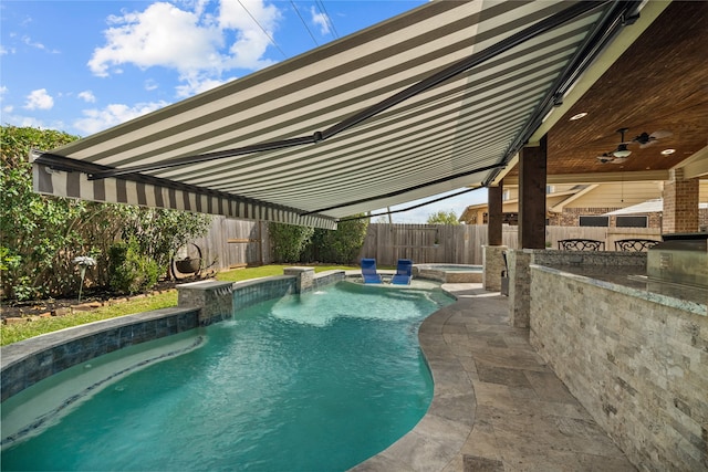 view of pool with ceiling fan, a patio area, an in ground hot tub, and pool water feature