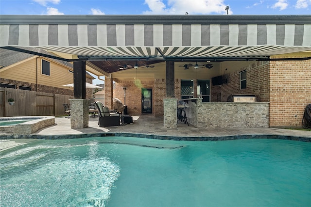 view of swimming pool featuring an outdoor bar, an in ground hot tub, ceiling fan, and a patio area