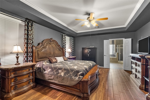 bedroom featuring crown molding, ensuite bath, ceiling fan, and hardwood / wood-style flooring