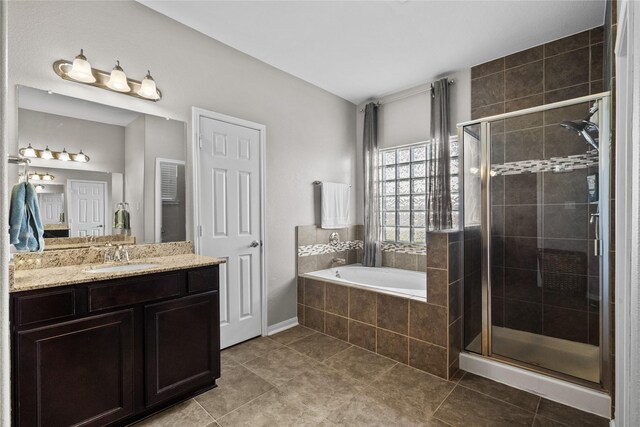 bathroom featuring shower with separate bathtub, tile patterned flooring, and vanity