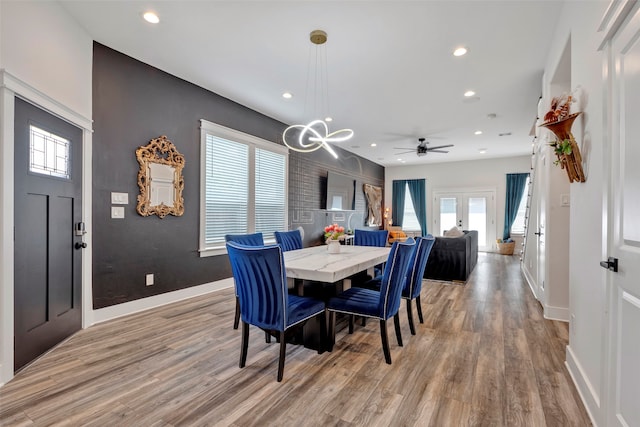 dining room with a notable chandelier, hardwood / wood-style flooring, and french doors