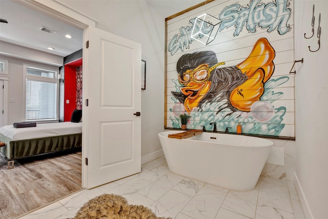 508 E 31st St, Houston, TX 77018 - ensuite bathroom featuring marble finish flooring, baseboards, a freestanding tub, and recessed lighting