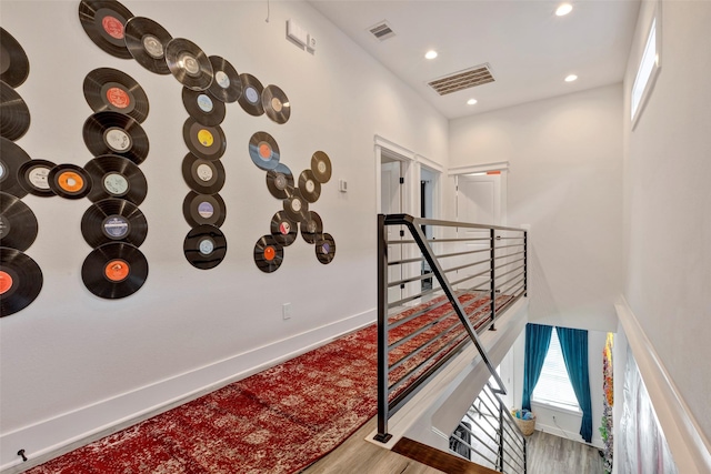 508 E 31st St, Houston, TX 77018 - stairway featuring wood finished floors, baseboards, and recessed lighting