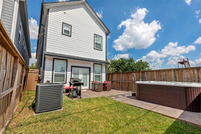 508 E 31st St, Houston, TX 77018 - rear view of property featuring central air condition unit, a hot tub, and a patio area