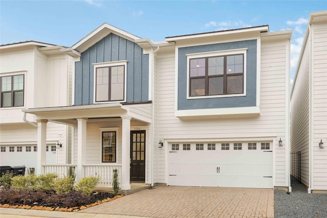 view of front of home featuring a porch and a garage