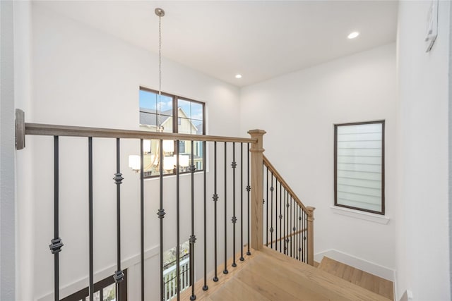 staircase with hardwood / wood-style flooring