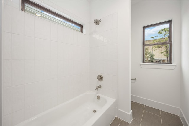 bathroom with tiled shower / bath and tile patterned flooring