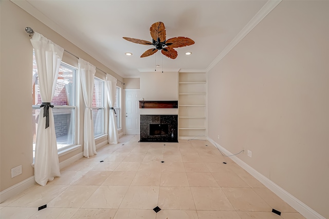 unfurnished living room with built in features, a premium fireplace, plenty of natural light, and ceiling fan