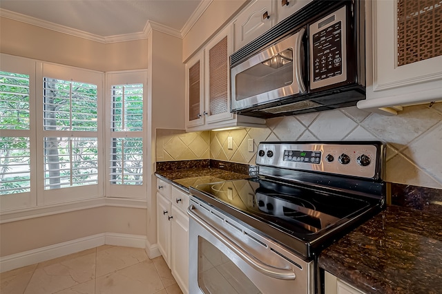 kitchen featuring ornamental molding, white cabinets, stainless steel appliances, and tasteful backsplash