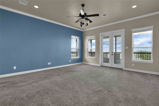 carpeted empty room featuring french doors, ornamental molding, and ceiling fan