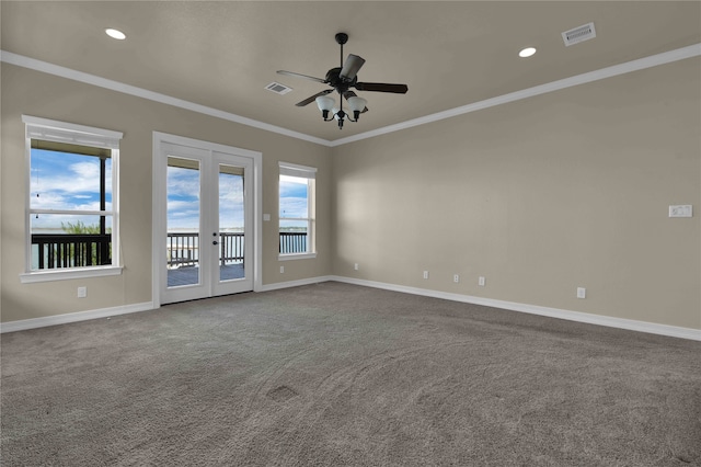 carpeted spare room featuring crown molding, ceiling fan, french doors, and plenty of natural light