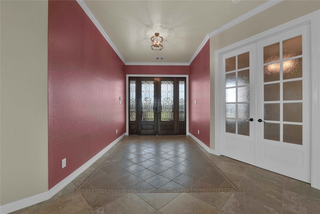 foyer with ornamental molding and french doors